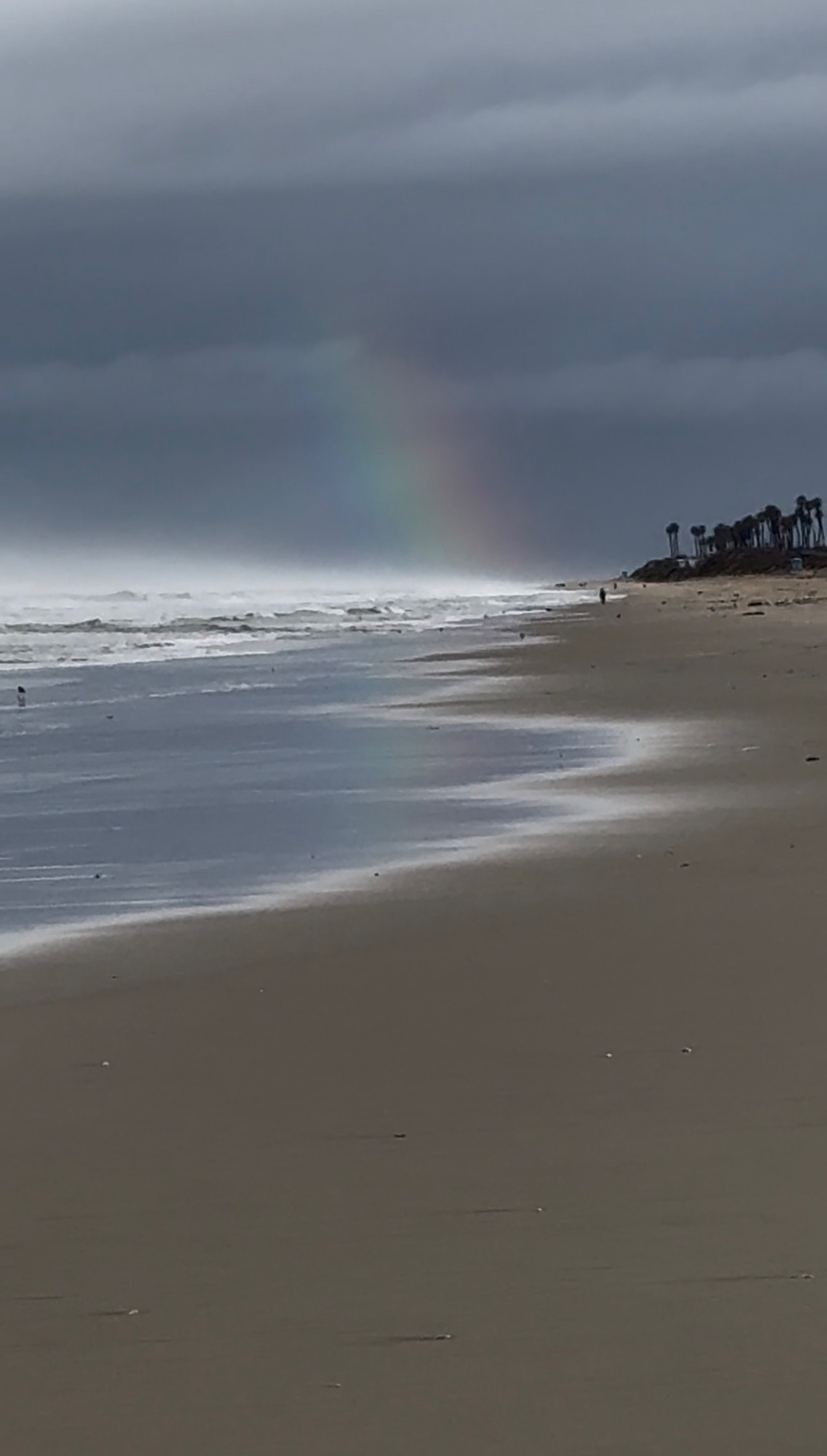 Rainbow and low tide at The Cliffs in Huntington Beach
